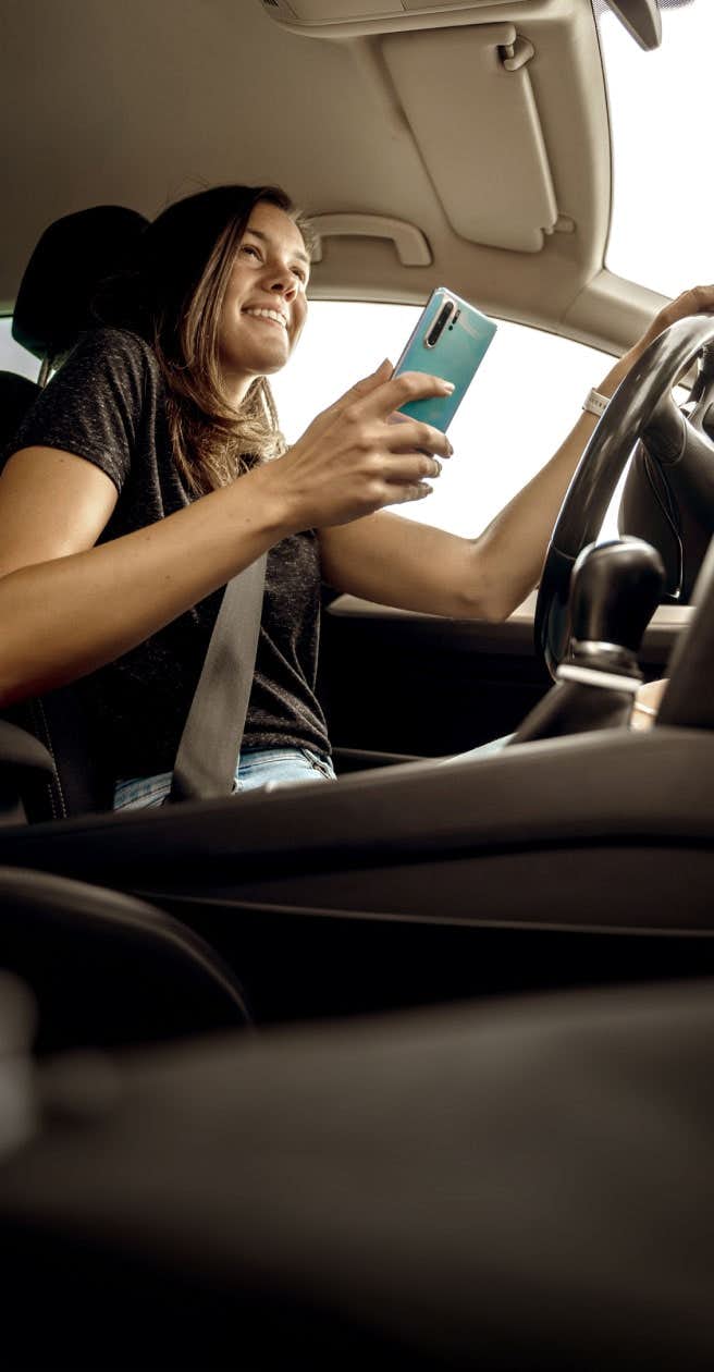 woman in car with phone